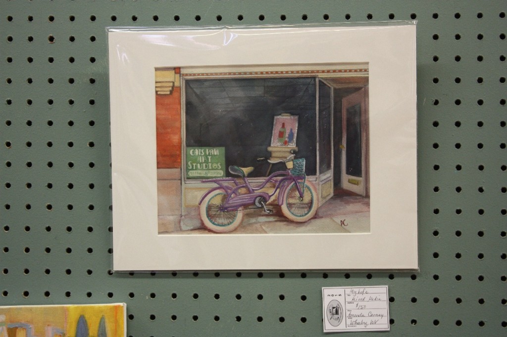 Amanda Carney’s plein air painting of her bike and shop.