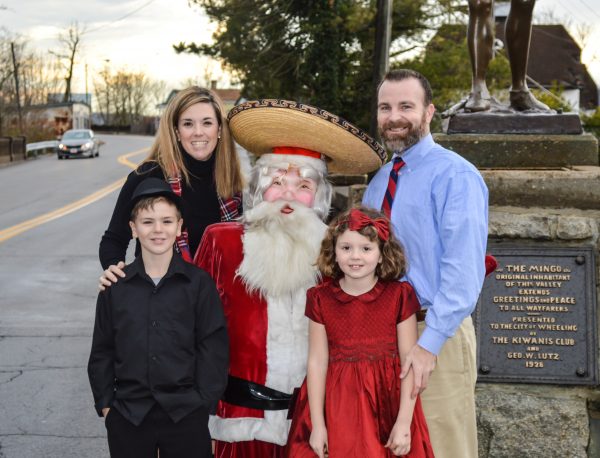 The Ashmore family recently borrowed the "Fiesta Santa" that once attracted customers to Reichart's in downtown Wheeling. for a family portrait. Ben is now nine years old, and Sammie is seven. 