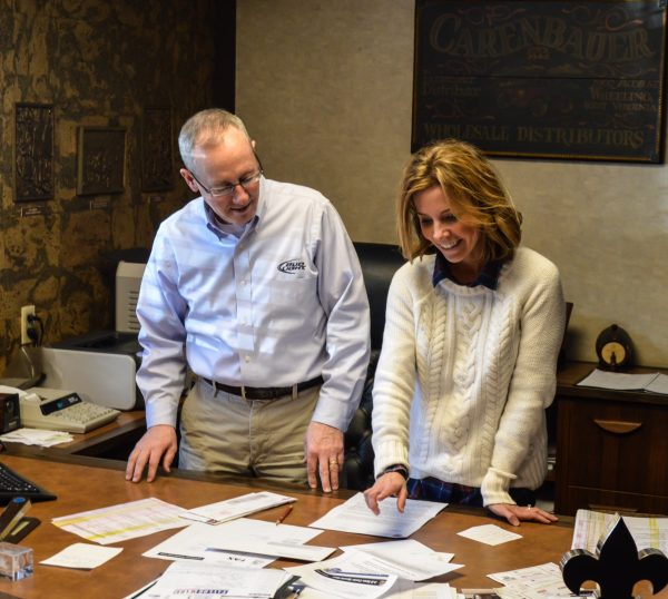 Carl Carenbauer and his daughter Erin review some of the donation requests the company receives on a daily basis.