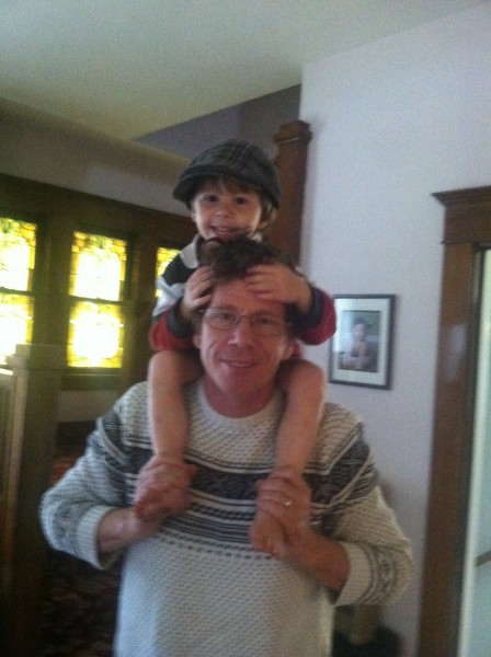 Tristan on the shoulders of his father, Jim Greer.