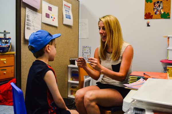 Therapist Olivia Figaretti works on reading and verbal skills with a student.