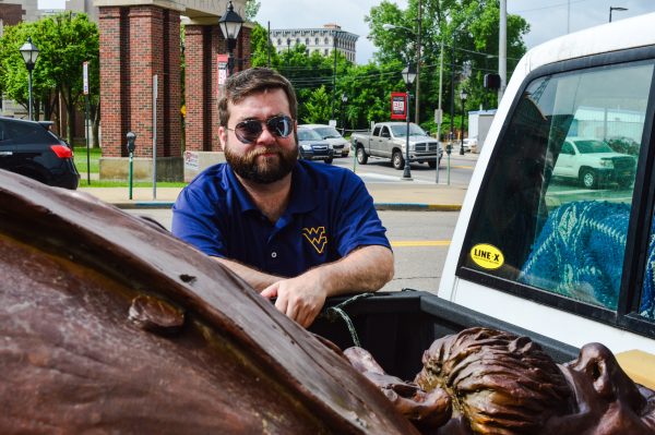 Jeremy Morris, executive director of the Wheeling National Heritage Area Corp., examines the statue before it is placed on the corner of 16th and Market streets.
