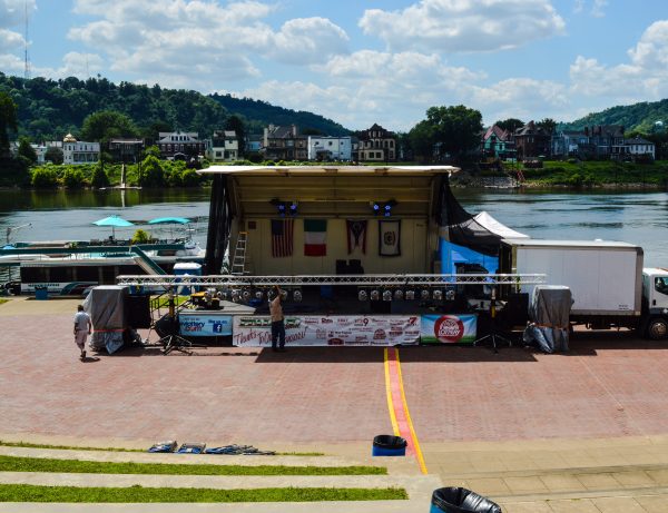 Crews work Friday on setting up the festival's main stage at the base of Heritage Port.