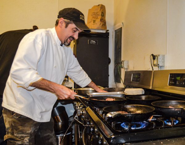 Employee Joe Cottage mans the stovetop at the Wheeling Brewing Company.