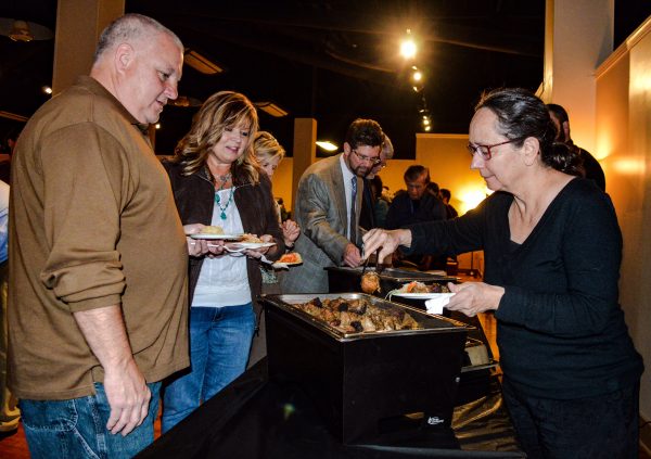 North Wheeling resident Vera Uyehara prepares to enjoy the catering supplied by the "Vagabond Chef," Matt Welsch, while Wheeling councilman Don Atkinson and his wife Gail waits their turn.