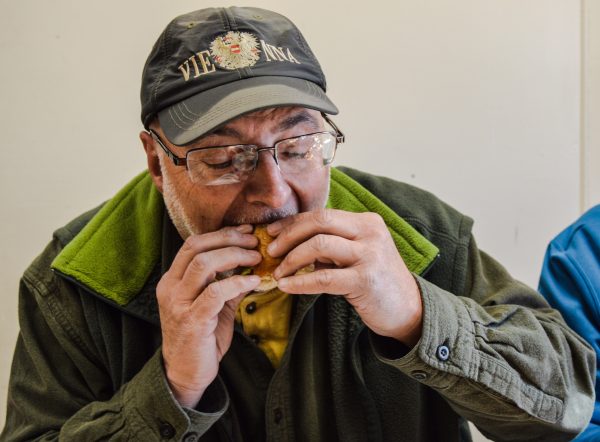 Gregg Boury bites into a replica of his all-time favorite - the Slim Jim - at Bob's Lunch.