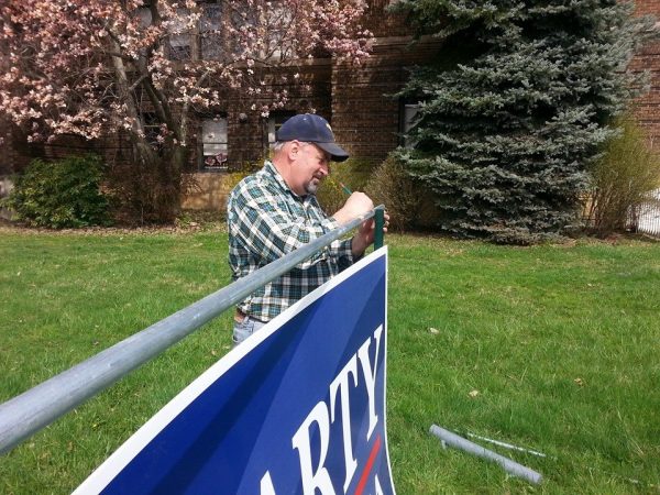 Fluharty's father assists the lawmaker's campaign with the campaign signs located throughout the Third House District.