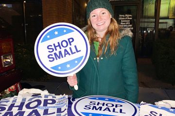 Valerie holding a "Shop Small" sign
