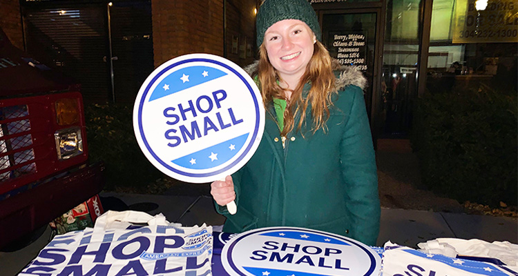 Valerie holding a "Shop Small" sign