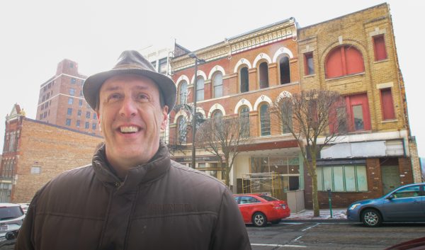 Gabe Hays standing in front of downtown buildings