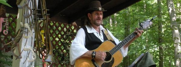 Balladeer Terry Griffith playing guitar.