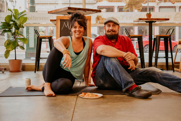 Laura Hitchman and Chef Ryan Butler in yoga poses at The Public Market